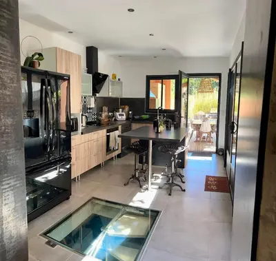 a stone wall in a kitchen with a sink at MAS DE VILLE AVEC PISCINE DANS SON COCON DE VERDURE - ESPRIT INDUSTRIEL in Carpentras