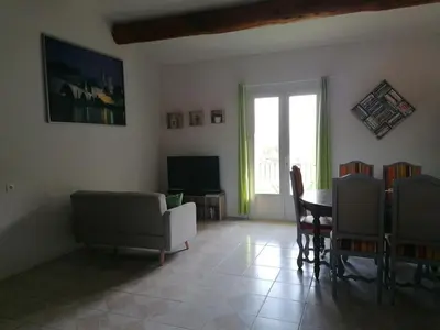 a living room with a couch and a table at Le Tavan in Crillon-le-Brave