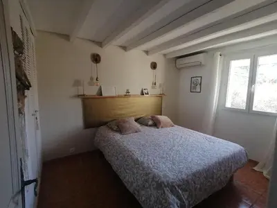 a bedroom with a bed with two pillows on it at Le Tavan in Crillon-le-Brave