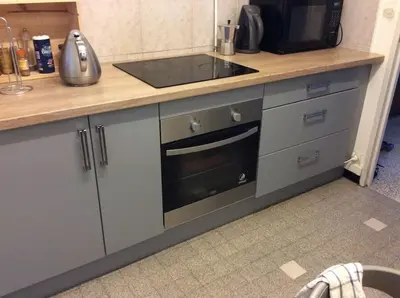a kitchen with a counter with a sink and a stove at Les Cerisiers. in Aix-en-Provence