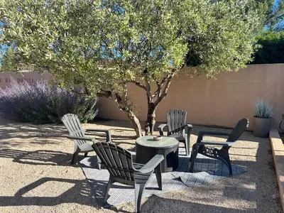 a group of chairs and a table and a tree at Mas Moucia in Mormoiron