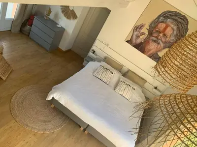 a bedroom with a bed with a painting on the wall at Mas Moucia in Mormoiron
