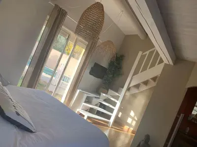 a bedroom with a bed and stairs in a room at Mas Moucia in Mormoiron