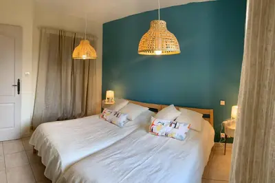a bedroom with a large white bed with two pillows at Mas Moucia in Mormoiron