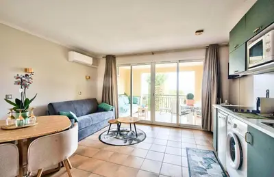 a kitchen and living room with a couch and a table at Village Pont Royal en Provence - maeva Home - Appartement charmant et climatisé 2 pièces 4 personnes - Prestige - super Home MAE-4884 in Mallemort