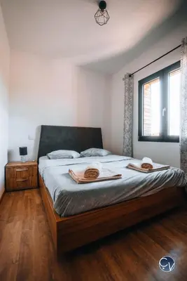 a bedroom with a bed with two hats on it at Villa Moderne avec Jacuzzi proche d'Avignon in Le Thor