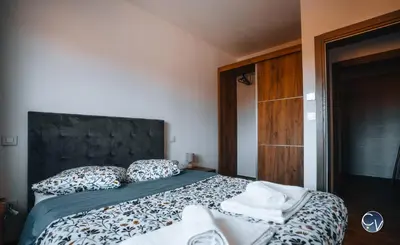 a bedroom with a large bed with towels on it at Villa Moderne avec Jacuzzi proche d'Avignon in Le Thor