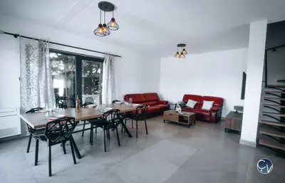 a living room with a table and chairs and a couch at Villa Moderne avec Jacuzzi proche d'Avignon in Le Thor