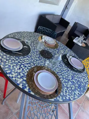 a table with plates and chargers on top of it at La Ferme l'Etang in Vachères