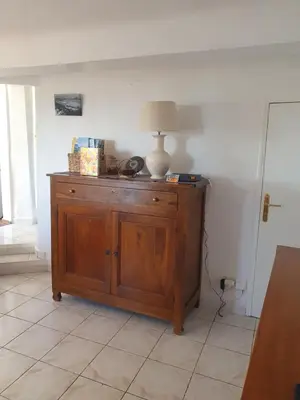 a lamp on top of a wooden cabinet in a room at La Ferme l'Etang in Vachères