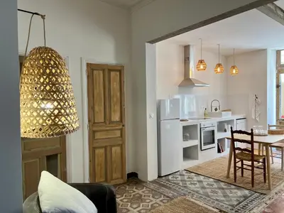 a living room with a kitchen and a dining room at La Maison de Lola in Carpentras