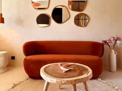 a living room with a orange couch and a table at Love in L'Isle/Sorgue L'Aurore in LʼIsle-sur-la-Sorgue
