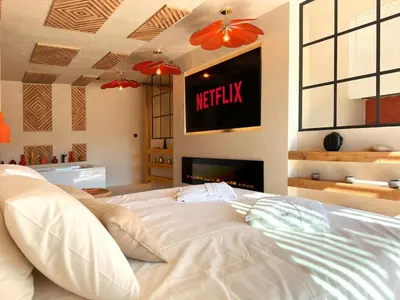 a white bed in a room with a fireplace at Love in L'Isle/Sorgue L'Aurore in LʼIsle-sur-la-Sorgue