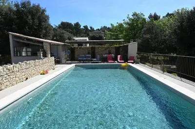 a swimming pool in the backyard of a house at Gîte Bienvenue Chez Nous in Ménerbes