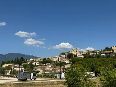 a truck driving down a road in a town at Moun Cabanoun in Carpentras