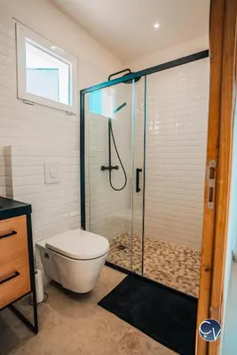 a bathroom with a toilet and a glass shower at Villa le Thor Piscine Billard Sauna et Jacuzzi in Le Thor
