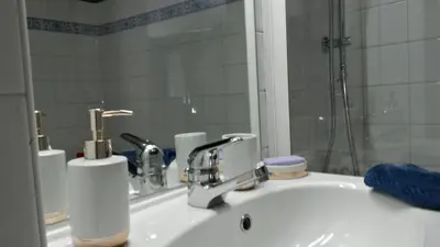 a bathroom sink with a faucet and a mirror at Centre d'Aix - charmant appartement 1 chambre Pythagore avec parking in Aix-en-Provence