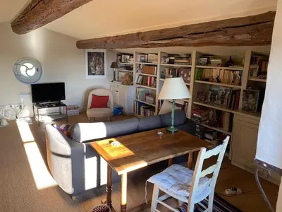 a living room with a couch and a table at In Gordes, facing the entire Luberon Park a beautiful 5 bedrooms house in Gordes