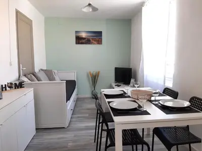 a kitchen and dining room with a table and chairs at AptCityStay in Apt