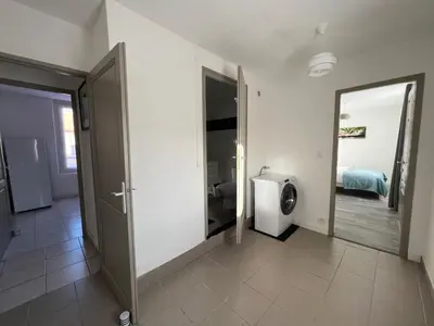 a bathroom with a toilet and a door to a room at AptCityStay in Apt