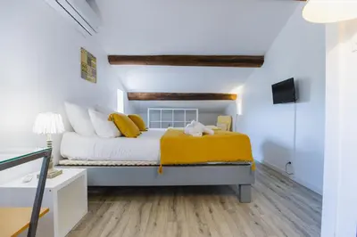 a bedroom with a bed with a yellow blanket at Gite Grand Luberon chez Manon en Luberon - Vacation rental in guest house in Lagnes