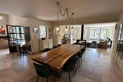 a living room with a large wooden table and chairs at La Terrasse Collongue in Lourmarin