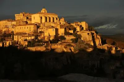 a group of buildings on a mountain at La petite Maison de Gordes in Gordes