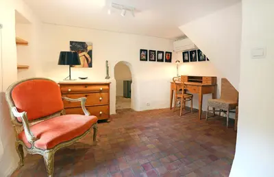 a living room with a chair and a desk at La petite Maison de Gordes in Gordes