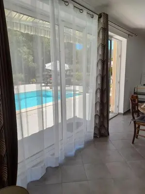 a room with a window with a view of a swimming pool at Villa le Bosquet en Luberon. in Ménerbes
