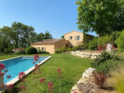 a yard with a swimming pool in front of a house at Chante Coucou in Saint-Saturnin-les-Apt