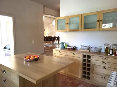 a kitchen with a bowl of fruit on a table at Chante Coucou in Saint-Saturnin-les-Apt