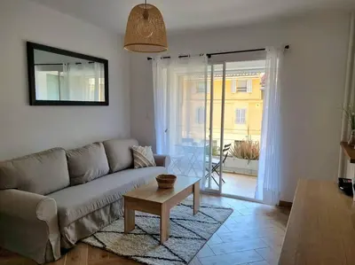 a living room with a couch and a table at Les studios d'Aurélia - Grand Théâtre de Provence in Aix-en-Provence