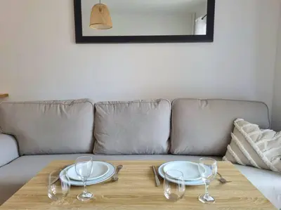 a table with plates and wine glasses on a couch at Les studios d'Aurélia - Grand Théâtre de Provence in Aix-en-Provence