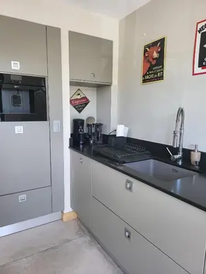 a kitchen with a sink and a counter top at Appartement standing bord Sorgue in LʼIsle-sur-la-Sorgue