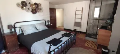a bedroom with a bed with a black blanket at LA JOVINE 2 Sault in Sault-de-Vaucluse