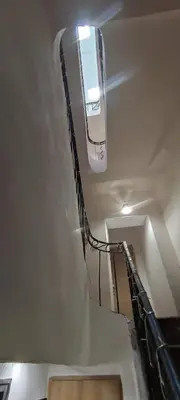 a staircase in a building with a light on the ceiling at LA JOVINE 2 Sault in Sault-de-Vaucluse