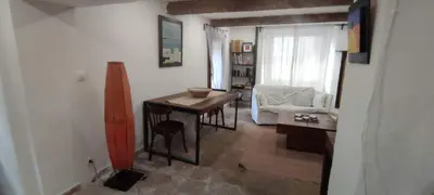 a small living room with a table and a chair at LA JOVINE 2 Sault in Sault-de-Vaucluse
