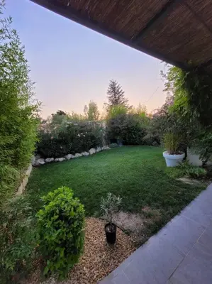 a backyard with a yard with a green lawn at Magnifique Villa avec Piscine en Provence in Verquières
