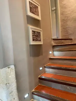 a stairway with two pictures on the wall at Ermitage Notre Dame de Vacquieres in Noves