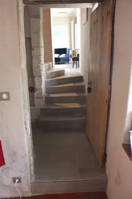 a hallway with stairs in a house with a door at Ermitage Notre Dame de Vacquieres in Noves
