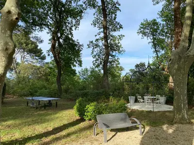 a picnic table and a bench in a park at Ermitage Notre Dame de Vacquieres in Noves