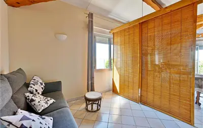 a living room with a couch and a window at 2 Bedroom Amazing Home In Châteaurenard in Châteaurenard