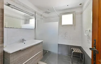 a bathroom with a sink and a mirror at 2 Bedroom Amazing Home In Châteaurenard in Châteaurenard