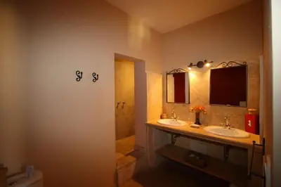 a bathroom with two sinks and a shower at Bastide Magnolia - Gite et chambres d 'hôtes Les dépendances, Roussillon in Roussillon