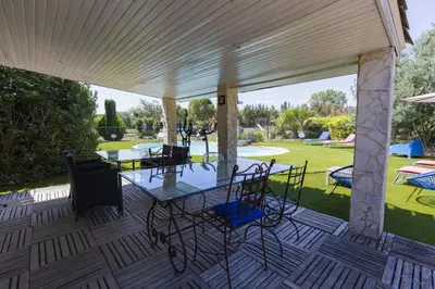 a patio with a table and chairs on it at Chambre d'hôtes - B&B - Grand Luberon chez Manon en Luberon in Lagnes