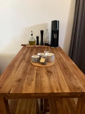 a wooden table with two bowls of food on it at Le mas des glycines - parking privé et terrasse ombragée in Salon-de-Provence