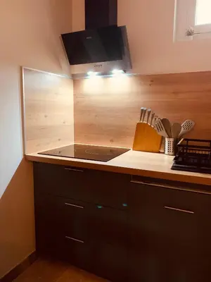 a kitchen with a stove and a counter top at Le mas des glycines - parking privé et terrasse ombragée in Salon-de-Provence