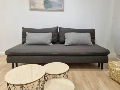 a couch with two tables in a living room at T2 Centre Historique Rénové in Aix-en-Provence