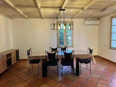 a dining room with a table and chairs at La Meynardière in Saint-Pierre-de-Vassols