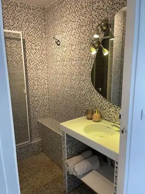 a bathroom with a sink and a mirror at Studio au cœur d'Aix avec balcon et parking in Aix-en-Provence